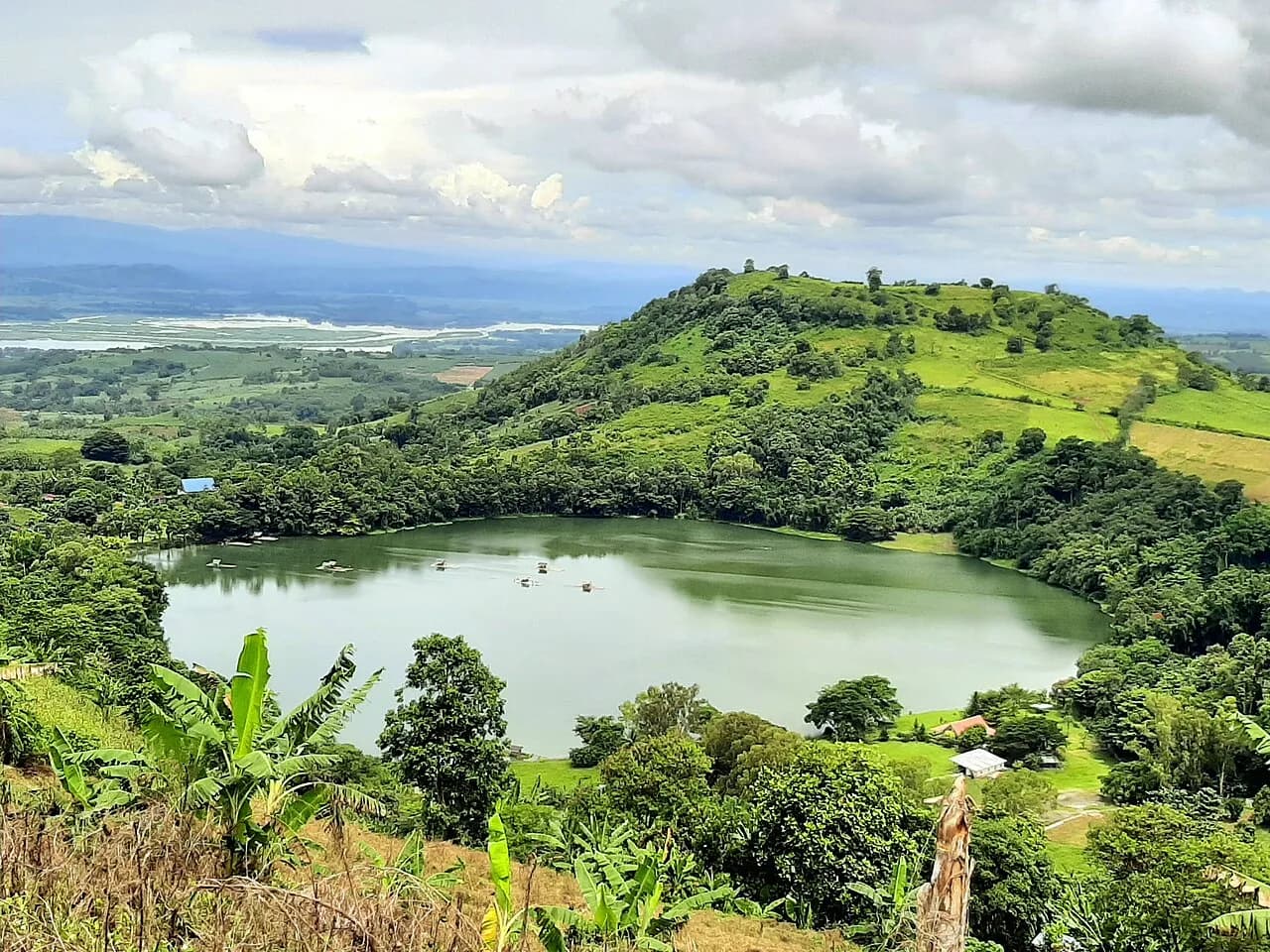 Lake Apo and its green surrounding hills in Valencia, Bukidnon